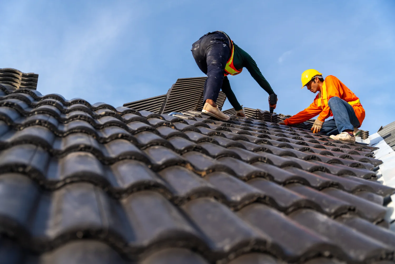 2-roofers-working-working-height-install-concrete-roof-tiles-new-roof-new-modern-building-construction
